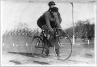 Eddie Root, famous Australian rugby player riding a bicycle